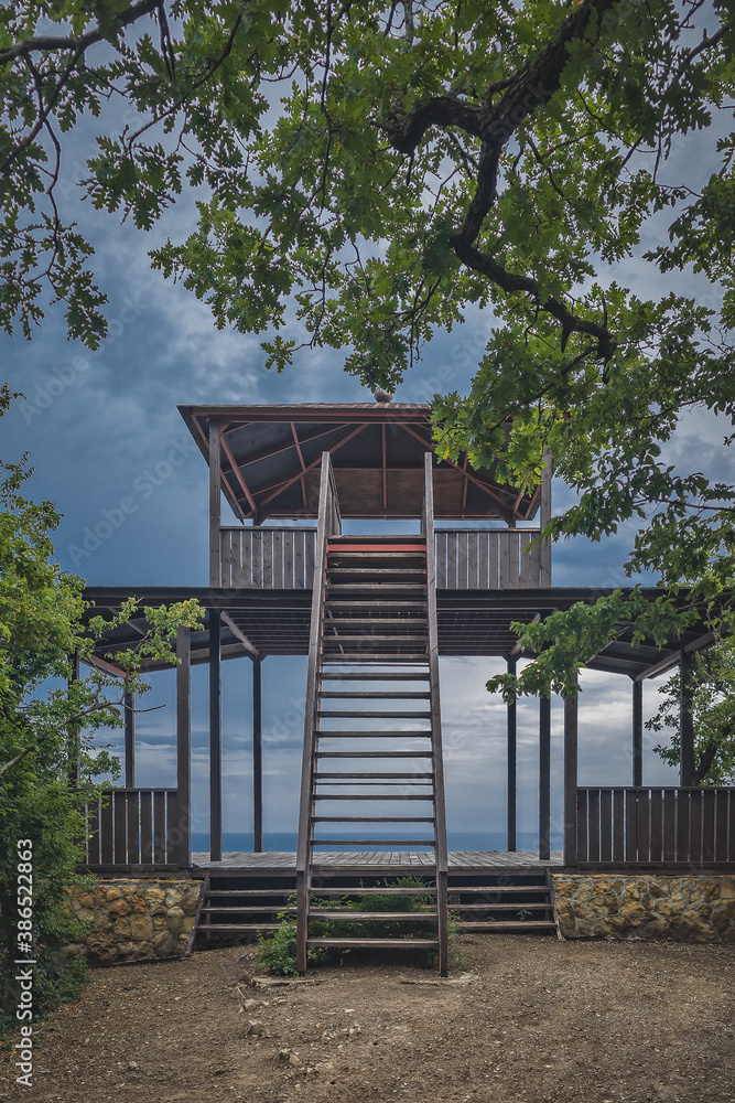 Wooden gazebo for yoga classes on the background of the sea Wooden gazebo for yoga classes on the background of the sea