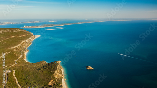 Aerial view of blue Atlantic ocean, green forest mountains and sandy beaches. Galapinhos Beach and Serra da Arrabida, Portugal. photo