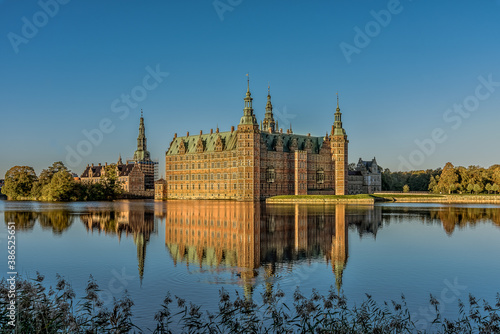 Frederiksborg Castle in a mirror-gloss reflection at surise photo