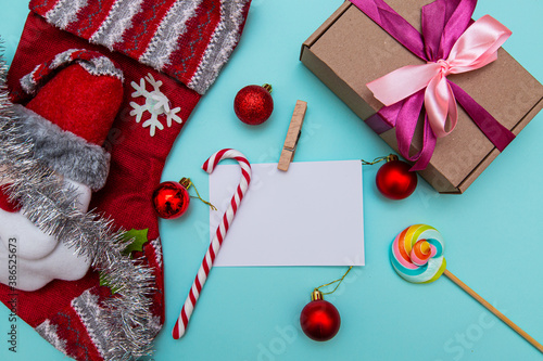 white sheet for inscriptions, candies, gifts, Christmas toys on a blue background © VikaEmerson
