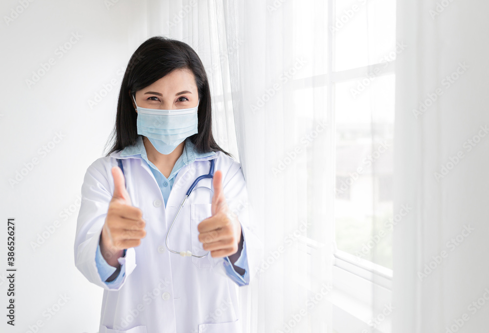 asian female doctor wear surgical mask before do work in hospital, she show thumb up sign with hand, influenza and coronavirus protection equipment, infection control asian female doctor wear surgical mask before do work in hospital, she show thumb up sign with hand, influenza and coronavirus protection equipment, infection control