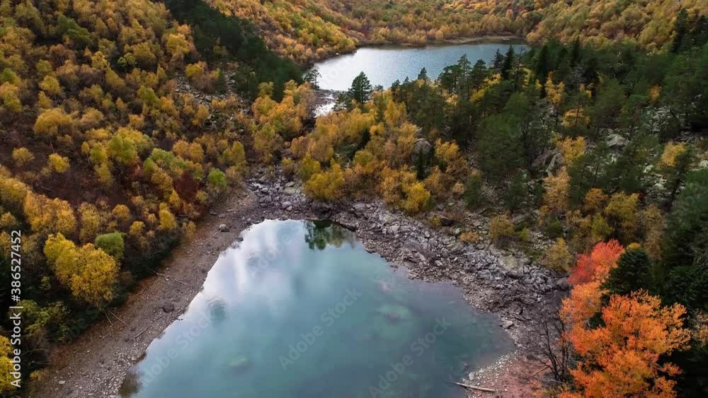 Mountain lake with blue water in a beautiful gorge. Autumn nature in the mountains of the North Caucasus
Mountain lake with blue water in a beautiful gorge. Autumn nature in the mountains of the North Caucasus