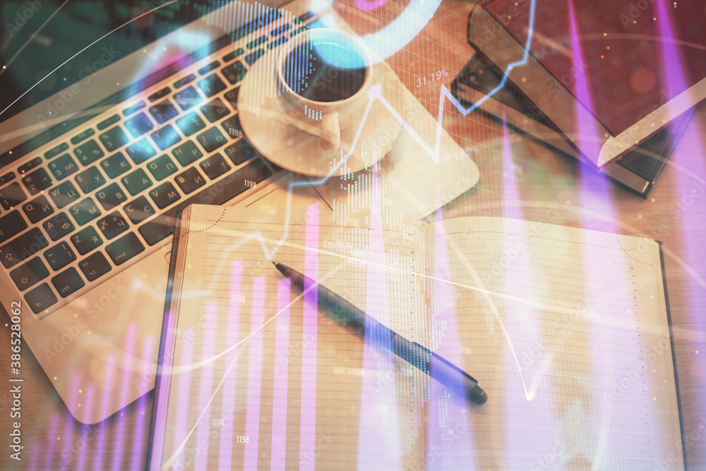 Stock market graph and top view computer on the table background. Multi exposure. Concept of financial education. Stock market graph and top view computer on the table background. Multi exposure. Concept of financial education.