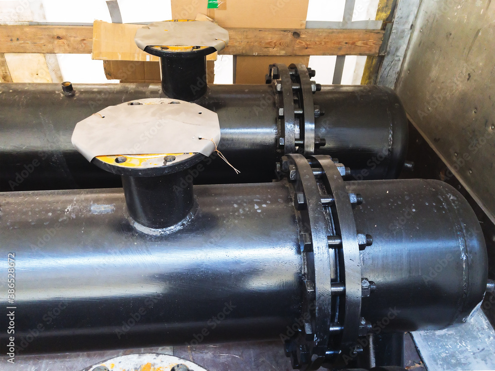 Black dusty Industrial heat exchanger, tube shell and tube high efficiency. Transportation in the truck. Wooden planks. For any purpose use Black dusty Industrial heat exchanger, tube shell and tube high efficiency. Transportation in the truck. Wooden planks. For any purpose use