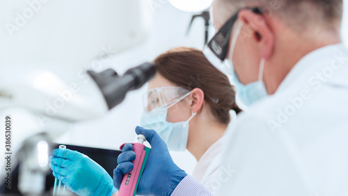 background image scientists conducting research in a medical laboratory.