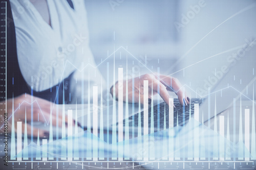 Double exposure of businesswoman hands typing on computer and forex graph hologram drawing. Financial analysis concept.