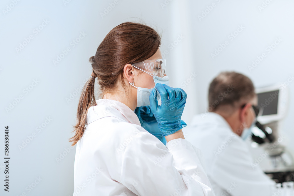 close up. female scientist sitting at a laboratory table. close up. female scientist sitting at a laboratory table.