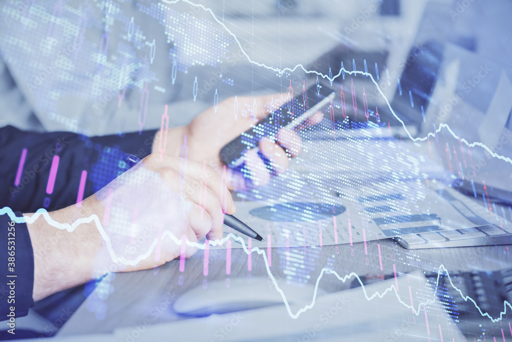 Double exposure of man's hands holding and using a digital device and forex graph drawing. Financial market concept. Double exposure of man's hands holding and using a digital device and forex graph drawing. Financial market concept.