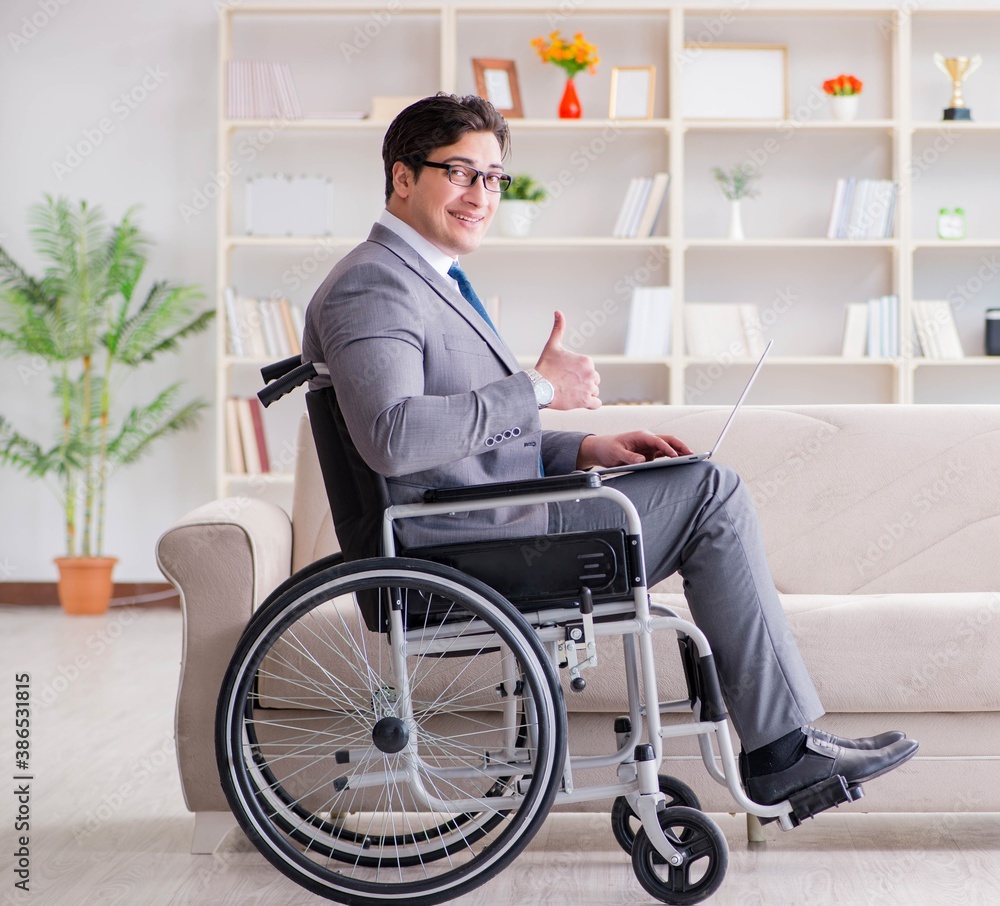 Dsabled businessman on wheelchair working home Dsabled businessman on wheelchair working home