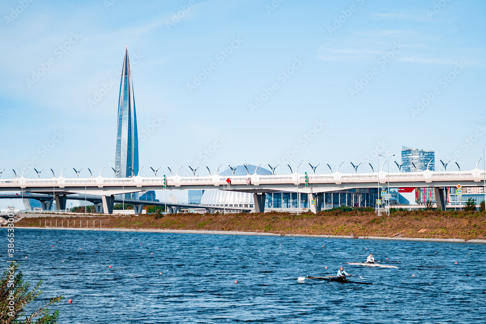 People train rowing, against of a bridge.