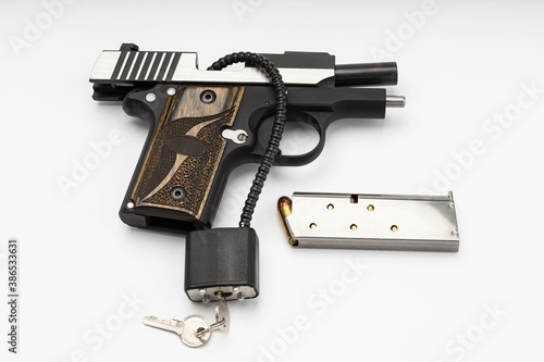 Locked disarmed and secured automatic gun on white background , Gun safety concept