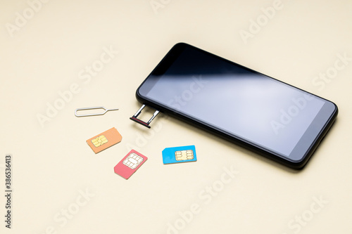 mobile phone or smartphone and variation of sim cards. different kinds of a mobile microchips. choose mobile service providers concept photo