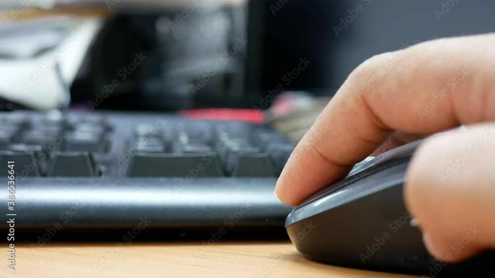 closeup of hand businessman clicking on mouse and working on computer at the office. closeup of hand businessman clicking on mouse and working on computer at the office.