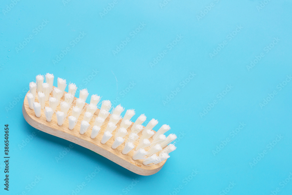 Wooden clothes brush on blue background. Wooden clothes brush on blue background.