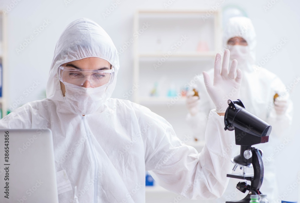 Two scientists working in the chemical lab Two scientists working in the chemical lab