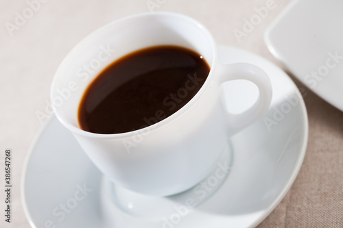 Picture of cup of fresh black coffee americano on table, no people
