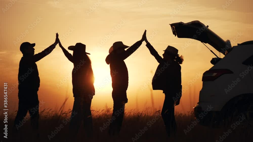 teamwork. team of tourists greet each other rejoice in success next to the car silhouette. business teamwork travel tourism concept. group of people clap each other symbol of victory success team teamwork. team of tourists greet each other rejoice in success next to the car silhouette. business teamwork travel tourism concept. group of people clap each other symbol of victory success team