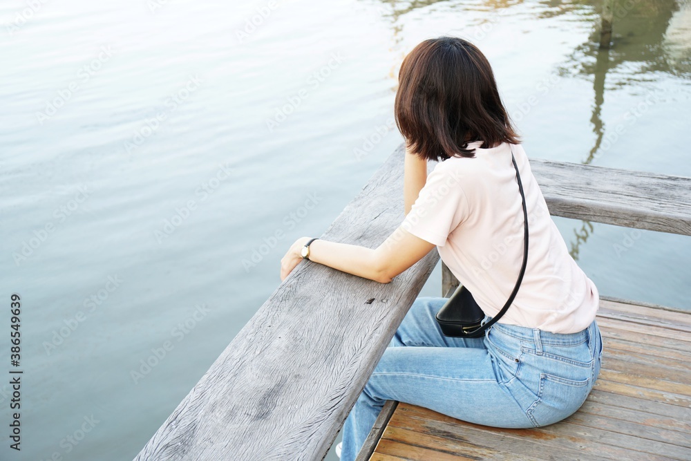 Young woman sitting on a pier