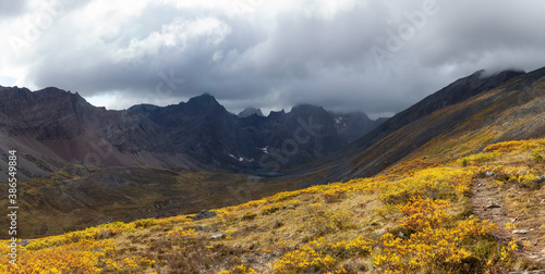 Panoramic View of Scenic Hiking Trail to Lake surrounded by Mountains during Fall in Canadian Nature. Taken in Tombstone Territorial Park  Yukon  Canada.