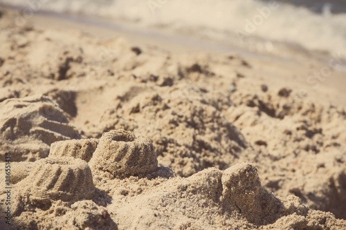 Different shapes made of sand on beach. Summer, vacation time and child development