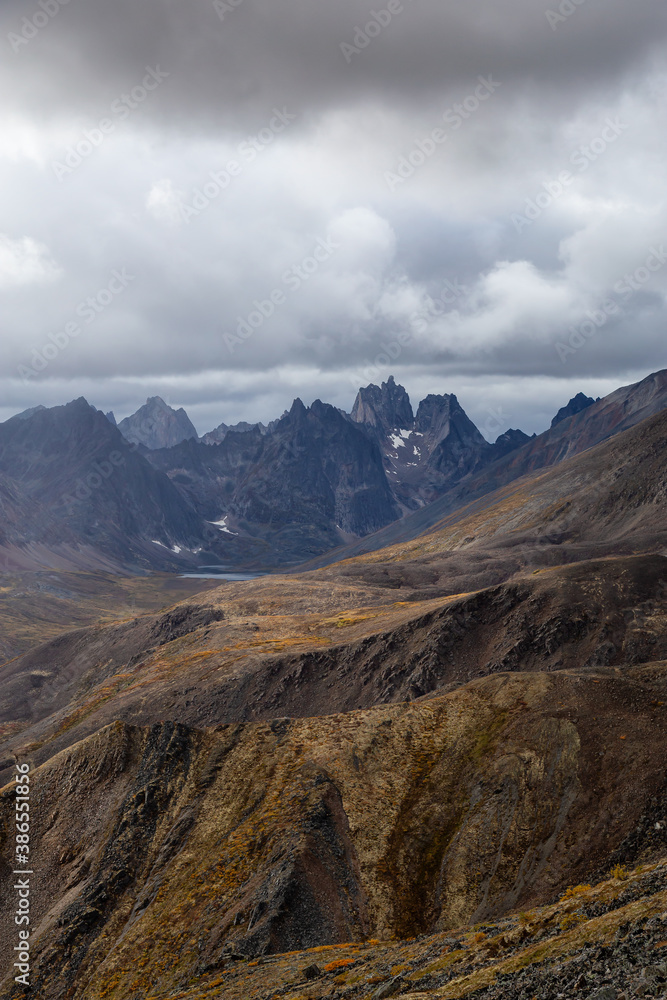 Beautiful View of Scenic Mountains, Lake and Landscape during the Fall Season in Canadian Nature. Taken in Tombstone Territorial Park, Yukon, Canada. Beautiful View of Scenic Mountains, Lake and Landscape during the Fall Season in Canadian Nature. Taken in Tombstone Territorial Park, Yukon, Canada.