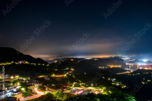 Jiufen village at night with mountain and ocrean view.