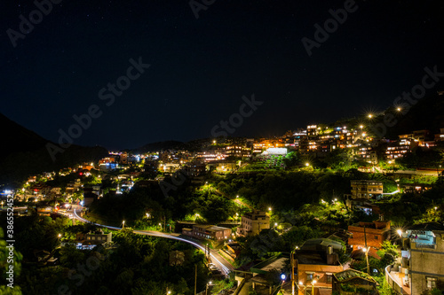 Jiufen village at night with mountain and ocrean view. photo