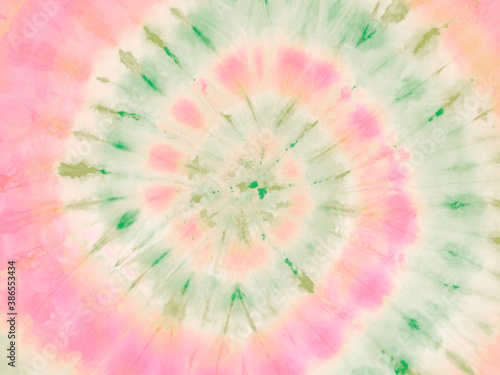 Spiral tie dye wallpaper. Hippie tie-dye background. Tiedye backdrop. Psychedelic tie dye pattern in watermelon red and green. 