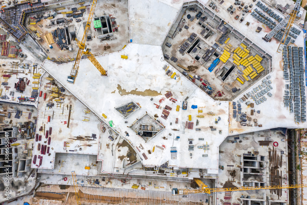 big construction site with working construction cranes. top view of foundation and construction equipment