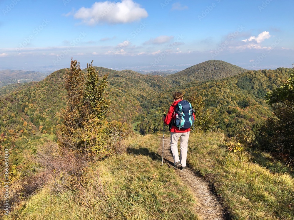 Fototapeta premium Senior woman hiking in autumn landscape