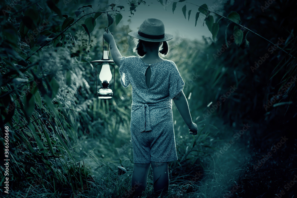 Fairytale, halloween concept with small girl walking in the night with lantern. Fairytale, halloween concept with small girl walking in the night with lantern.