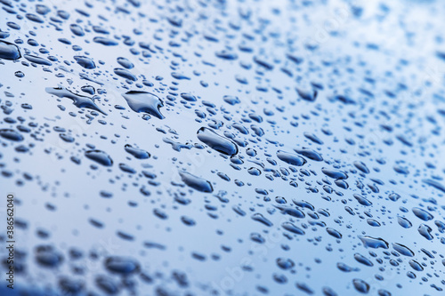 Water droplets are on shiny metal surface, background