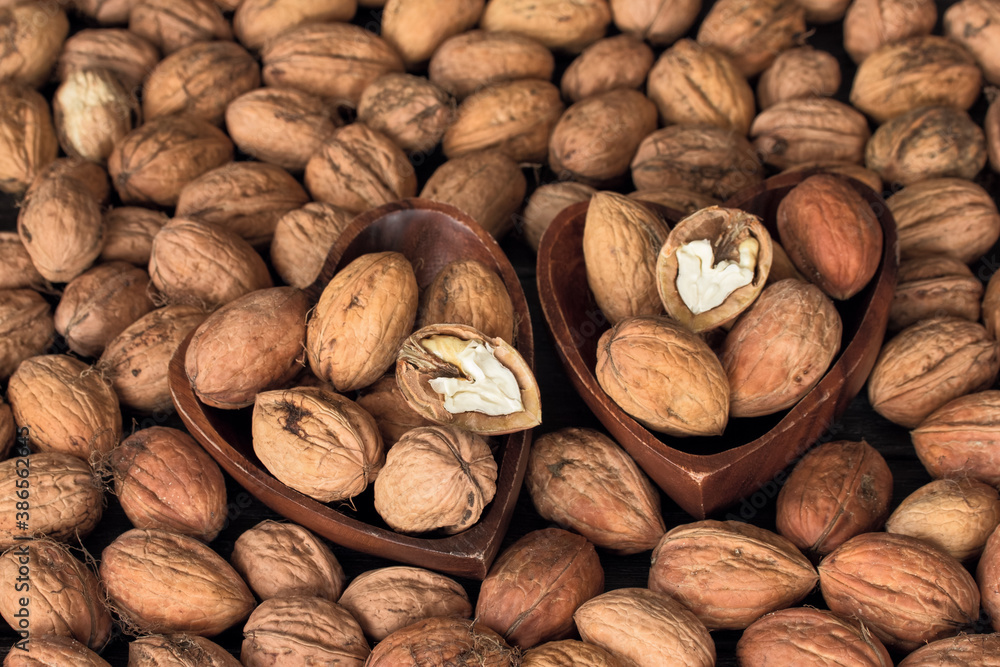 walnuts in wooden bowls close-up. background with walnuts. texture with walnuts. walnuts in wooden bowls close-up. background with walnuts. texture with walnuts.