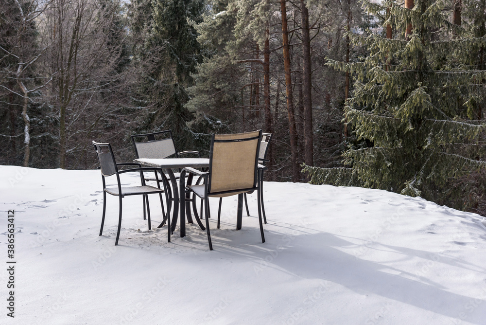 Table and chairs on a snow in Beski Sadecki mountains