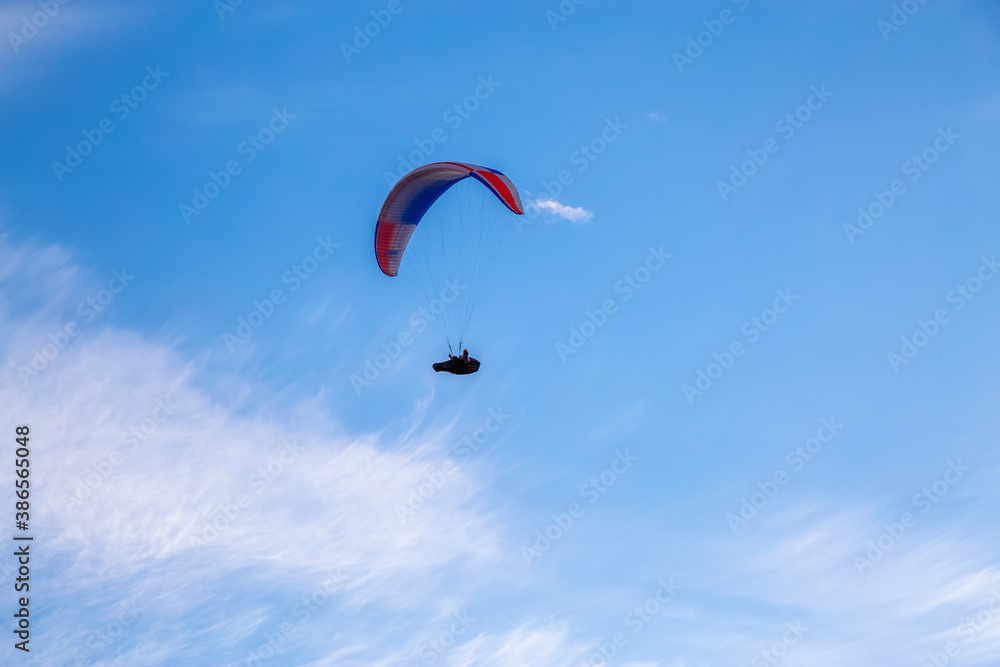 Paraglider flying Up High surrounded by Clouds in Canadian Nature. Taken in Tombstone Territorial Park, Yukon, Canada. Paraglider flying Up High surrounded by Clouds in Canadian Nature. Taken in Tombstone Territorial Park, Yukon, Canada.