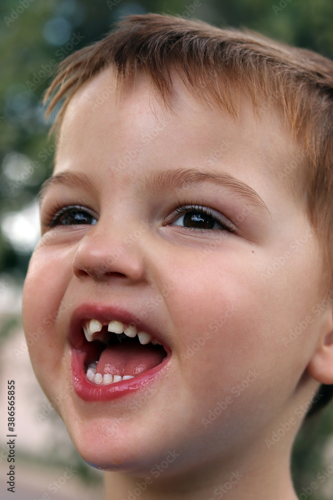 Close up of a young boy laughing