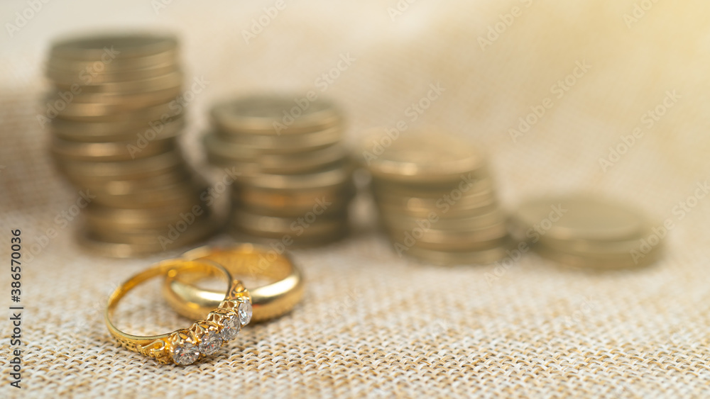 Wedding rings with stack of coins, saving money for marry. Wedding rings with stack of coins, saving money for marry.