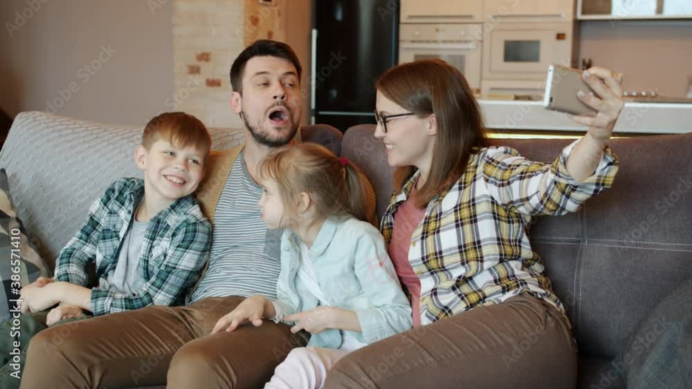 Slow motion of pregnant woman man boy and girl taking selfie and laughing at home enjoying leisure time and modern technology. People and photos concept. Slow motion of pregnant woman man boy and girl taking selfie and laughing at home enjoying leisure time and modern technology. People and photos concept.
