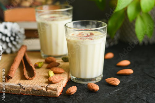 Kesar Badam milk shake or Almond Saffron milk prepared with almonds, spices and milk Kerala India. Kheer or North Indian traditional health drink Flavoured milk   badam lassi served with dry fruit photo