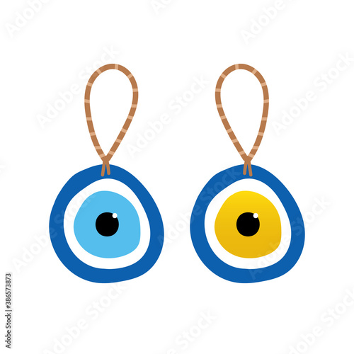 Couple of nazar amulets, evil eye protection talismans on rope. Turkish blue eye-shaped amulets. 
