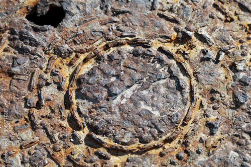 A rusty piece of metal with many elevations. A chaotic metal structure.