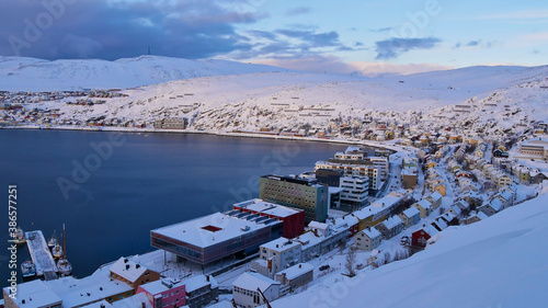 Panorama view of the snow-covered city center of Hammerfest, Norway, Scandinavia, the northernmost town in the world, located at a bay on the coast of the arctic sea. Afternoon sun in winter time. photo