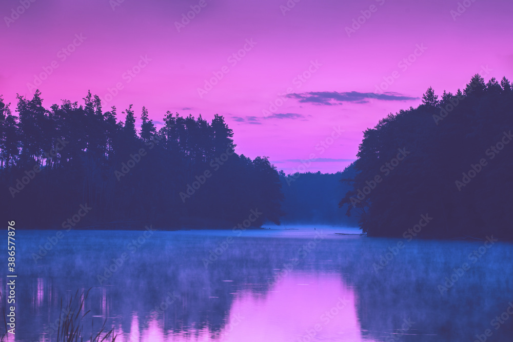 Magical pink sunset over the lake. Serene lake in the evening. Nature landscape