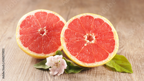 red grapefruit and leaf on wood background