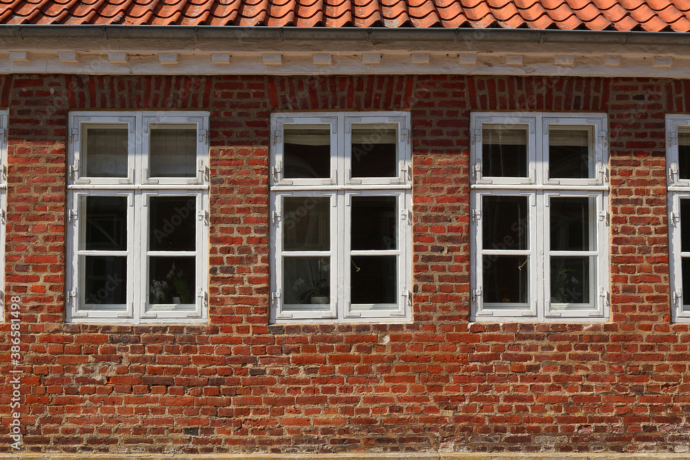 White wooden windows in red brick stone house (Jutland, Denmark) White wooden windows in red brick stone house (Jutland, Denmark)