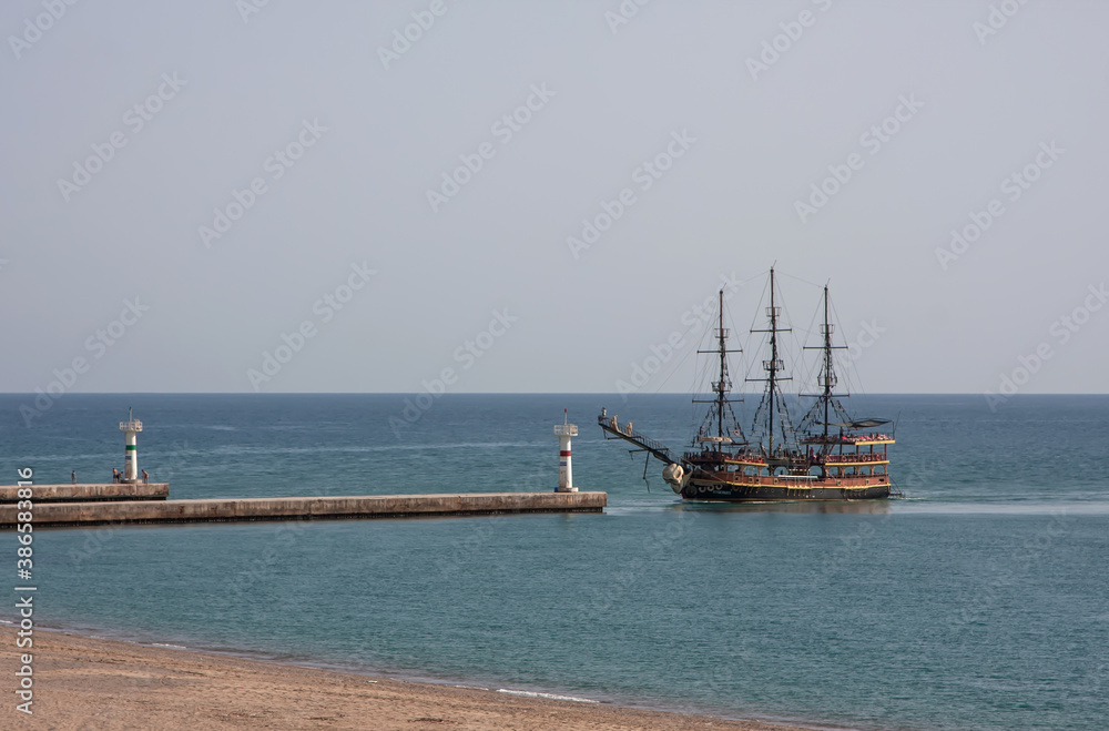 The ship sails towards the entrance to the river