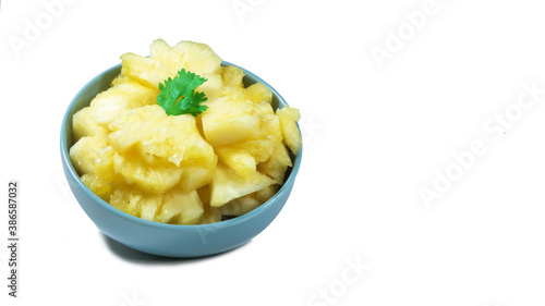 pineapple sliced serve on the blue bowl, closeup photoshoot & isolated on the white background.