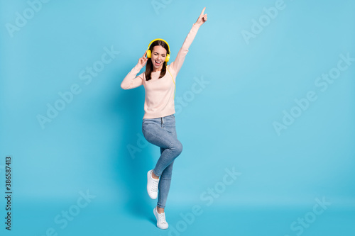 Full length body size view of her she nice attractive cheerful cheery glad girl fan listening hit bass having fun dancing isolated over bright vivid shine vibrant blue color background