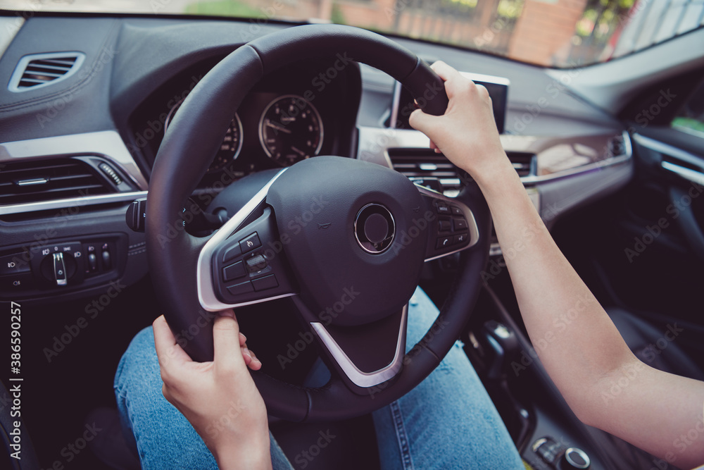 Cropped photo of cute pretty lady hands steering wheel road traveling ride highway turning beeping look speedometer use gps navigation professional driver skills wear white shirt indoors