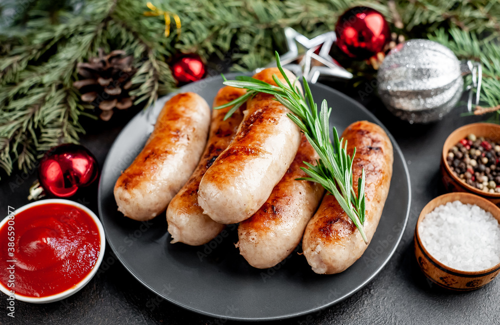 Christmas sausages with spices on a black plate on a stone background with Christmas trees and Christmas tree decorations, gifts with copy space
Christmas sausages with spices on a black plate on a stone background with Christmas trees and Christmas tree decorations, gifts with copy space